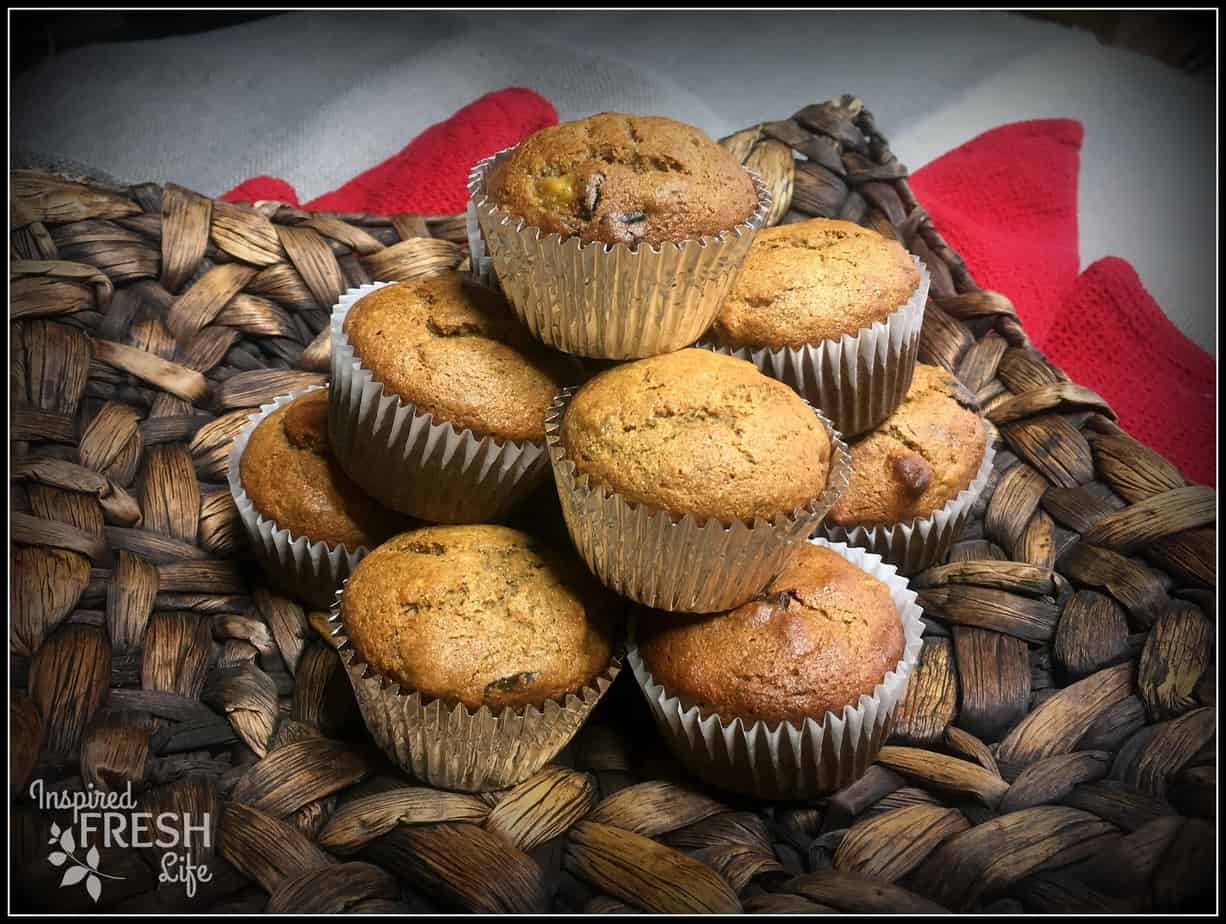 Banana Nut Muffins stacked on a brown platter.