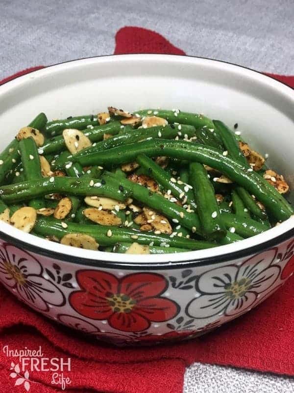 Toasted Sesame Green Beans garnished with sesame seeds in a serving bowl, close up view