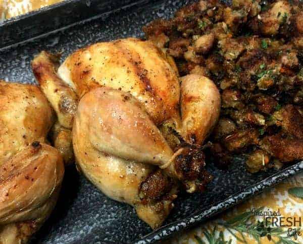 Stuffed Cornish Game Hens on a pewter platter.