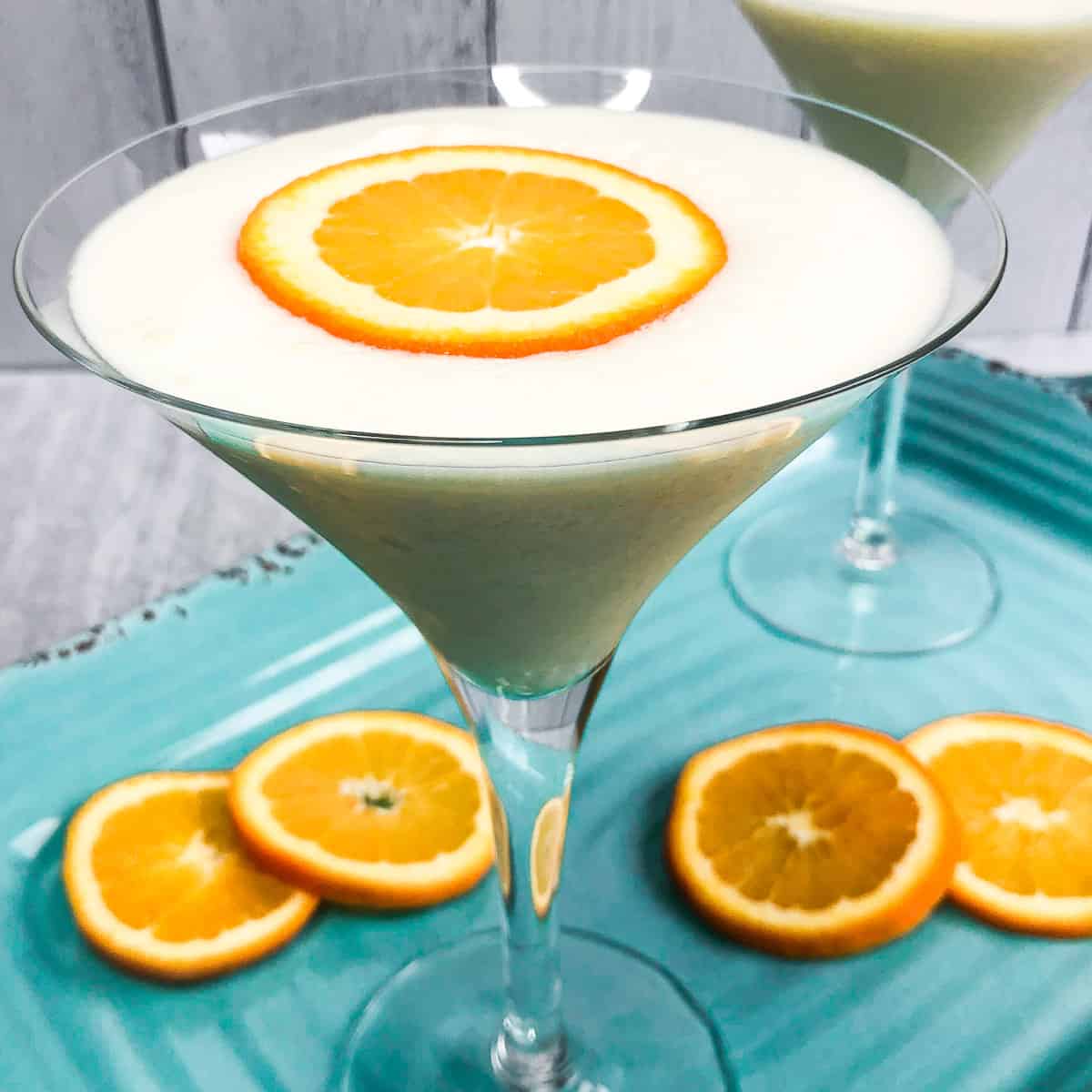 Creamsicle Martini with an orange slice floating on top.