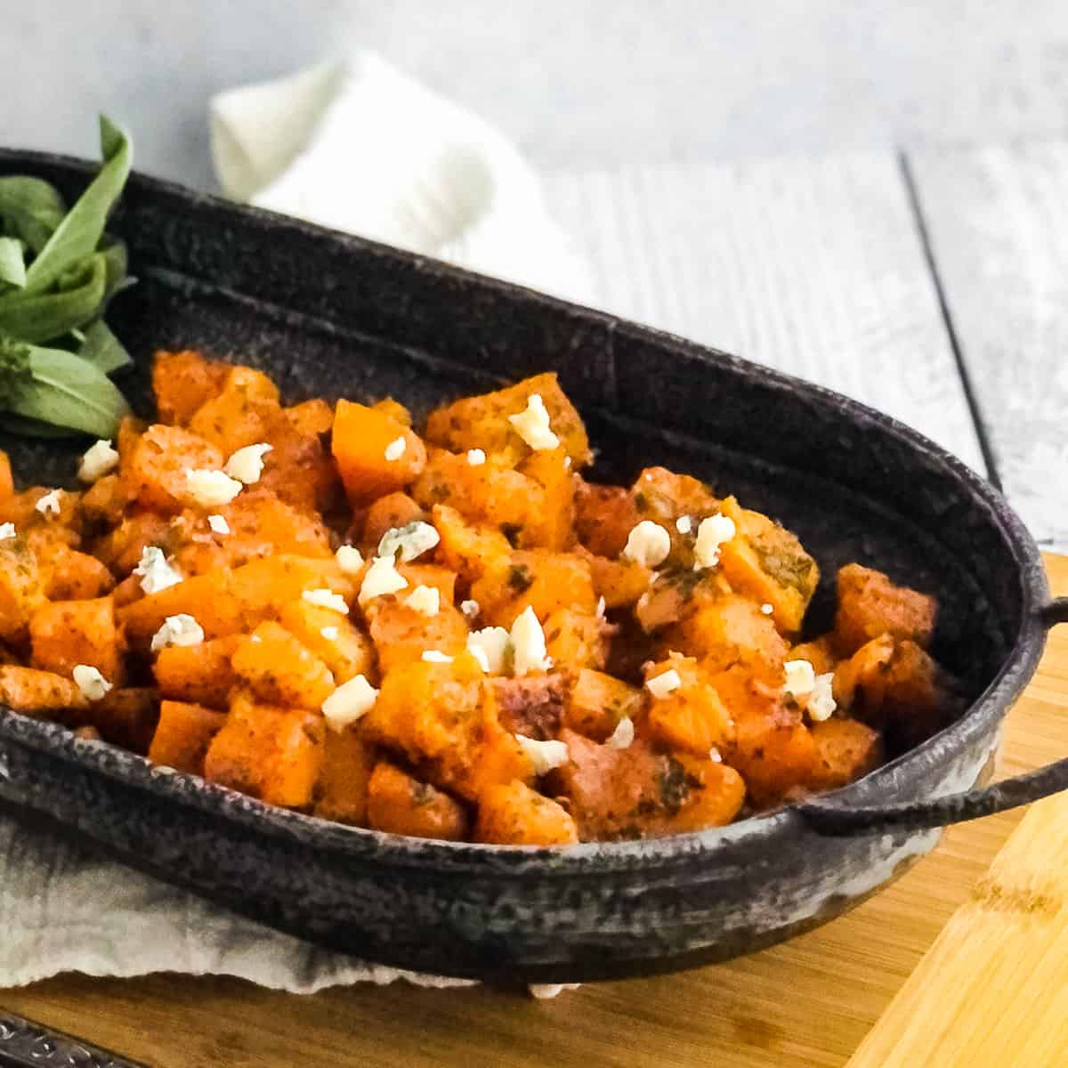 Roasted butternut squash topped with a sprinkle of gorgonzola cheese.