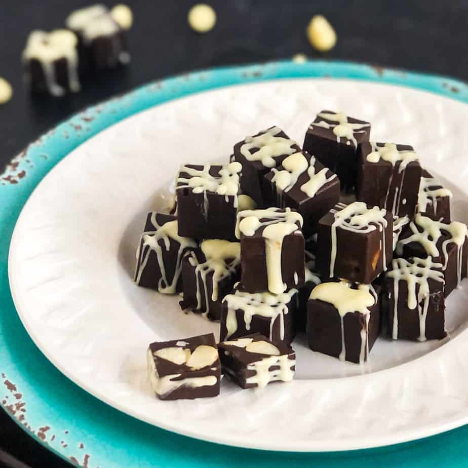 Homemade Filled Dark Chocolates drizzled with white chocolate on a white plate. 
