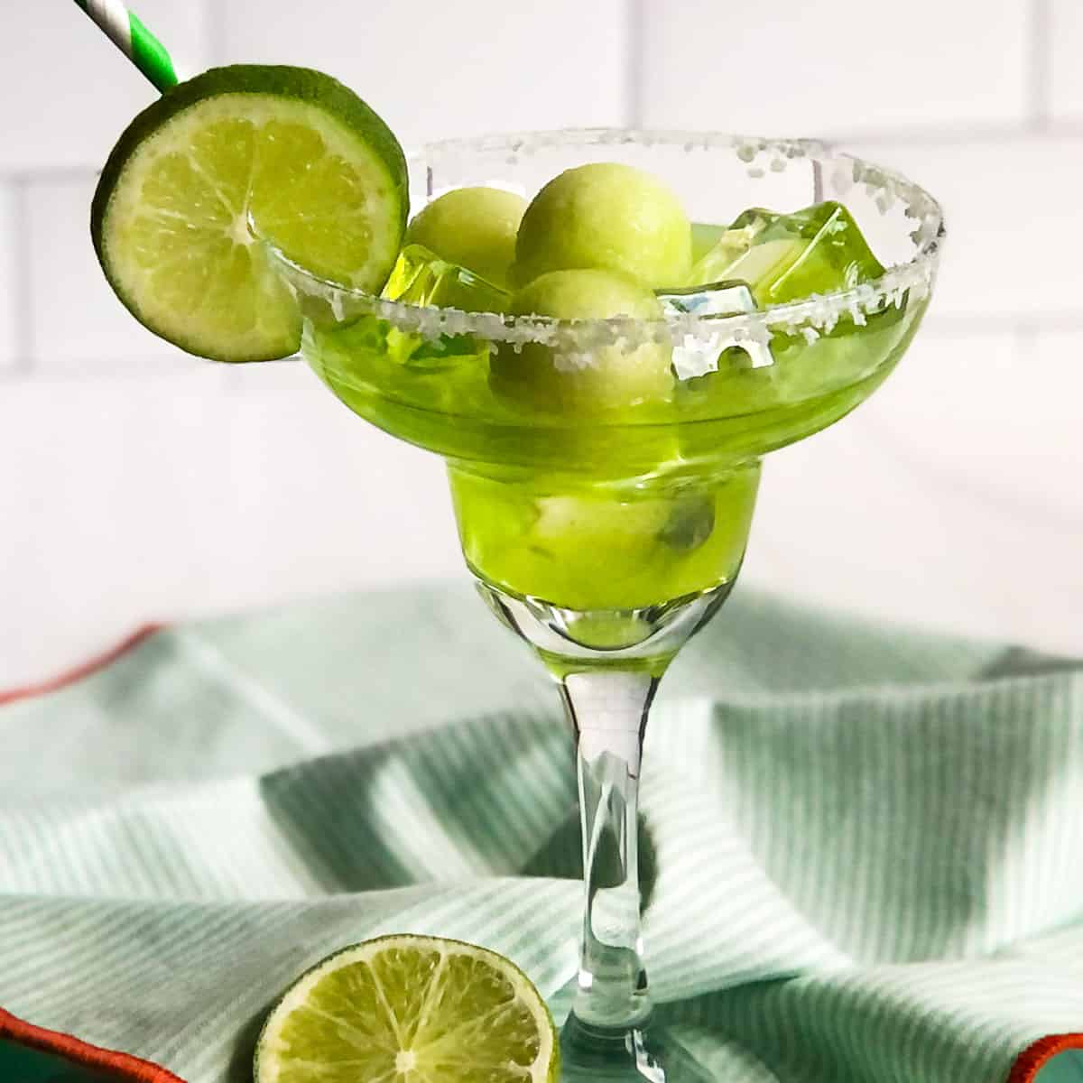 Melon Daiquiri garnished with melon balls and a lime wheel.